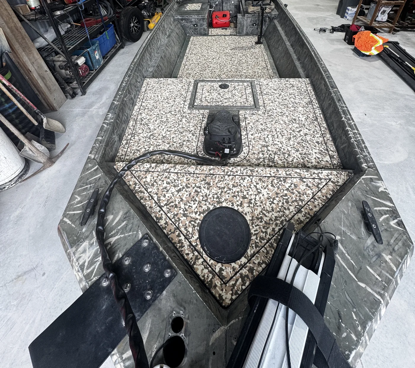 Polar Kraft duck boat with beige camo flooring in the shop