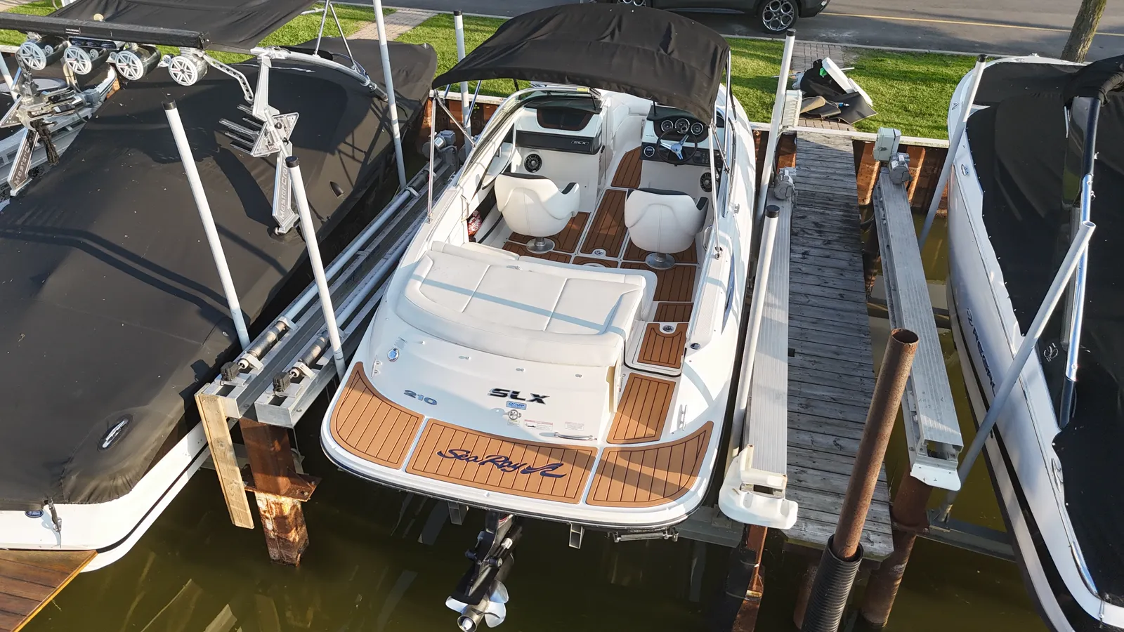 A 2014 Sea Ray 210 SLX on its lift with faux teak flooring