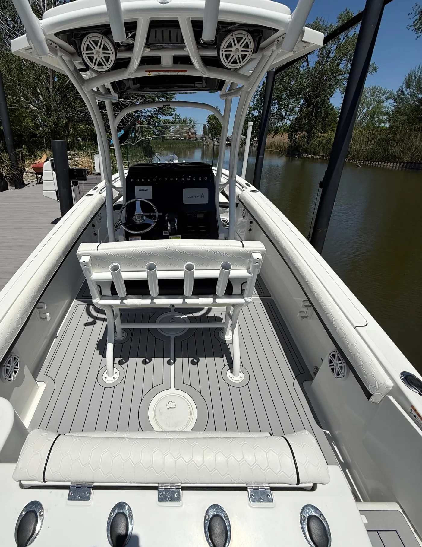 A 2020 Wellcraft Fisherman 222 with grey two-tone teak pattern flooring, seen from the T-top