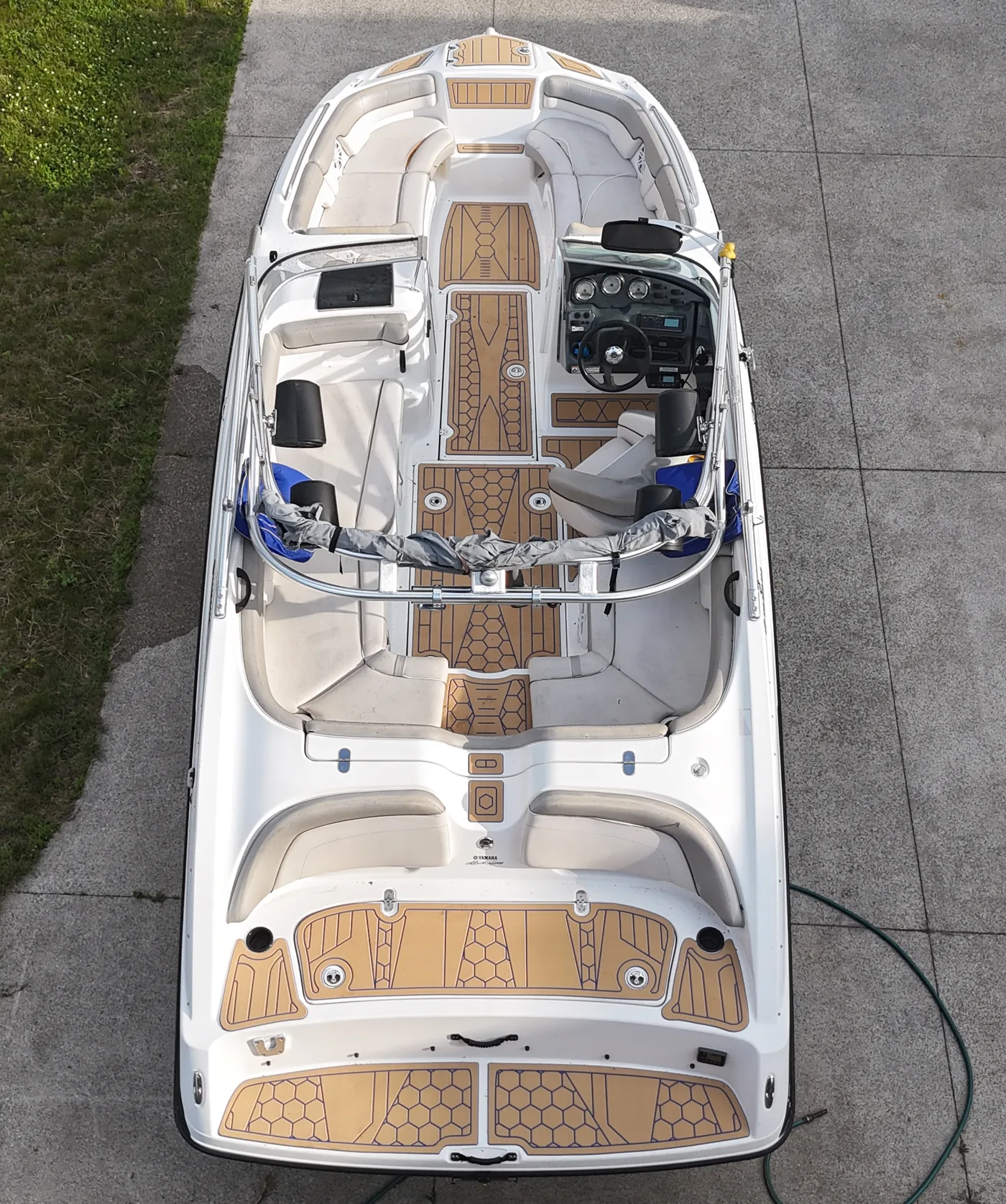 A 2012 Yamaha AR210 on its trailer, straight down from above, with tan hex and plank flooring
